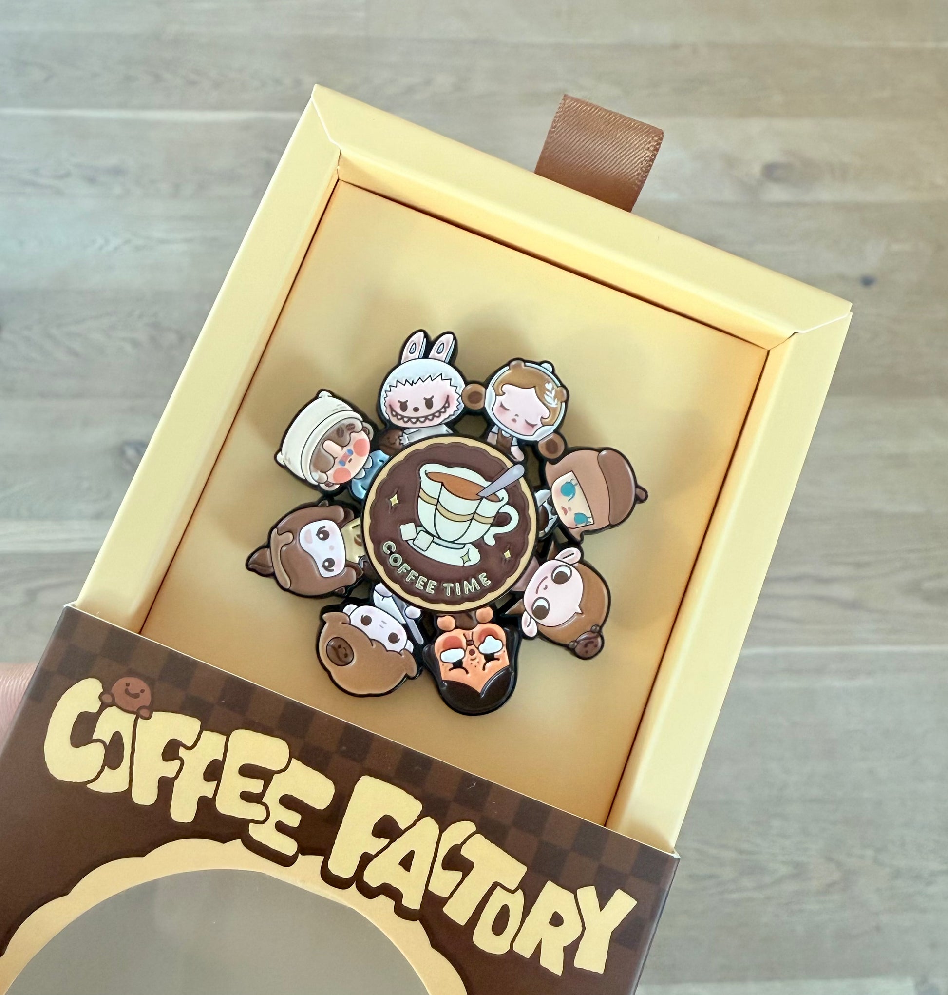 POP BEAN Coffee Factory Badge showing rotatable lower alloy piece mechanism